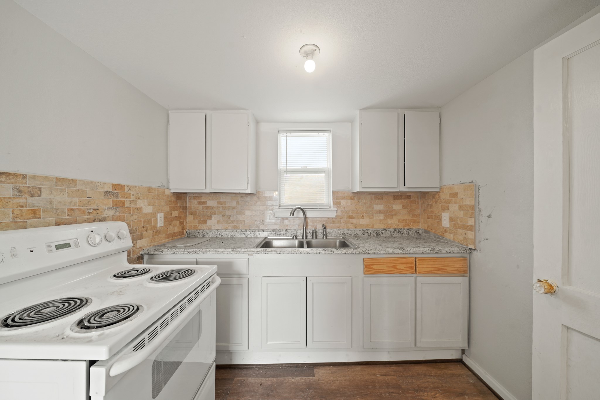 5307 Crane Street Houston, TX 77026 - Photo 14 of 41 a kitchen with a sink a stove and cabinets
