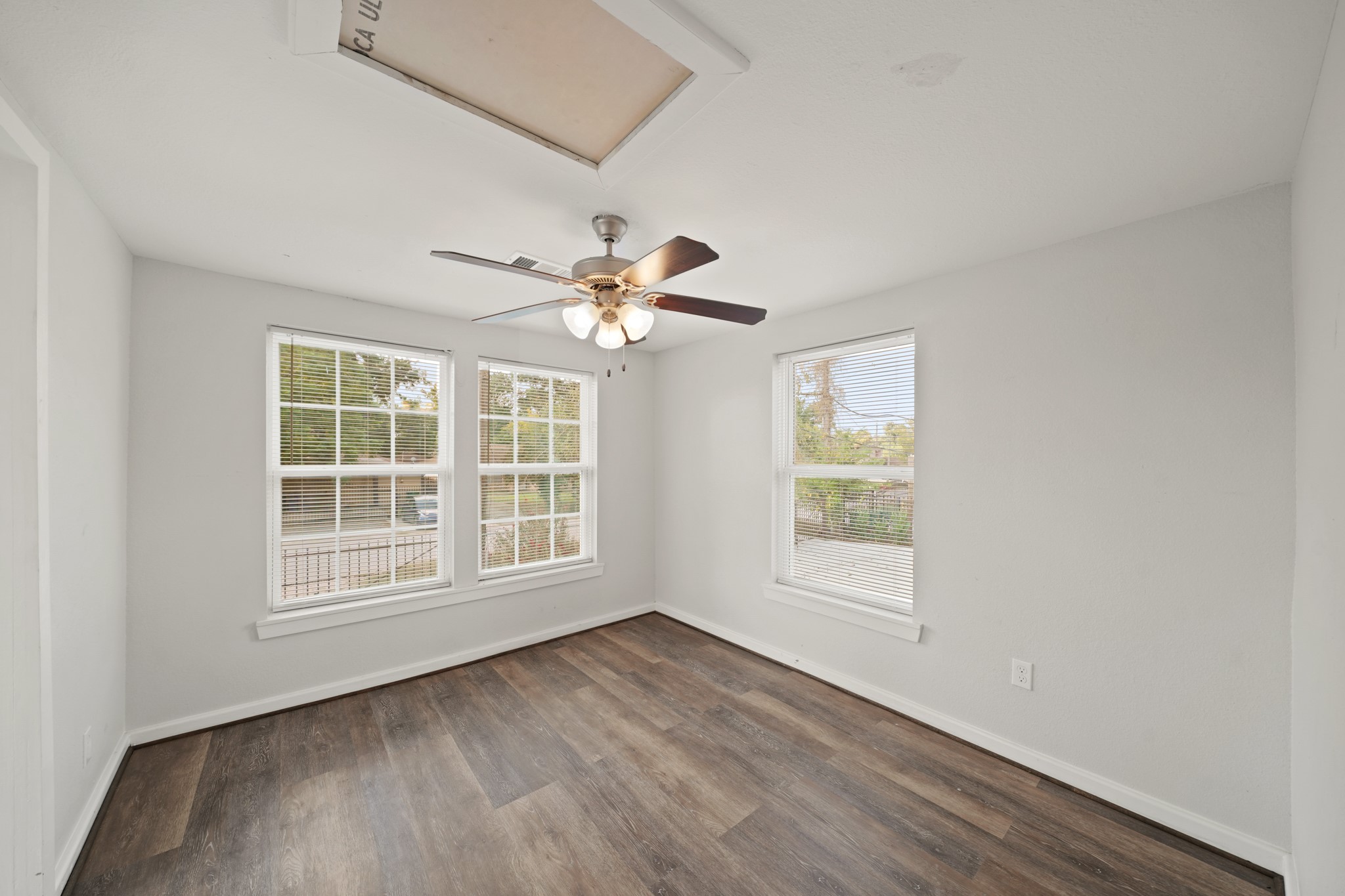 5307 Crane Street Houston, TX 77026 - Photo 18 of 41 an empty room with wooden floor chandelier fan and windows