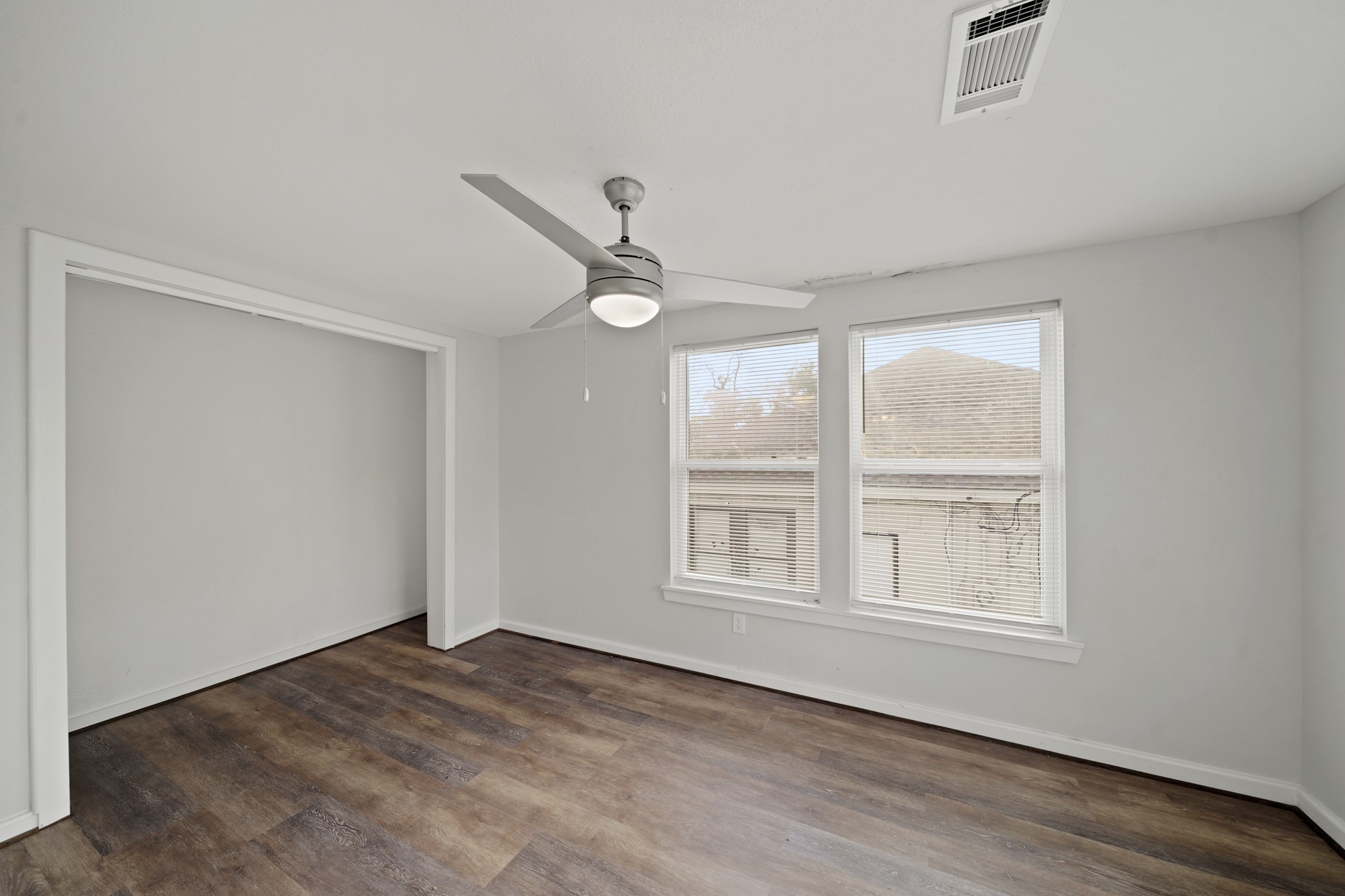 5307 Crane Street Houston, TX 77026 - Photo 19 of 41 a view of an empty room with a window and wooden floor
