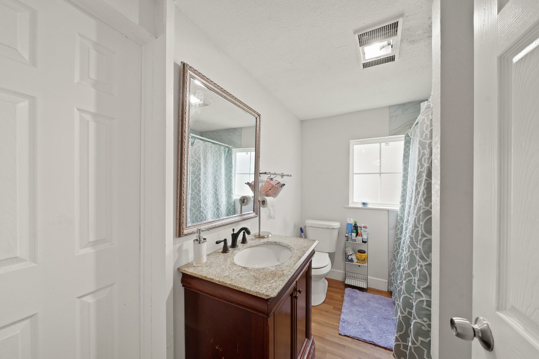 5307 Crane Street Houston, TX 77026 - Photo 27 of 41 a bathroom with a granite countertop sink and a mirror