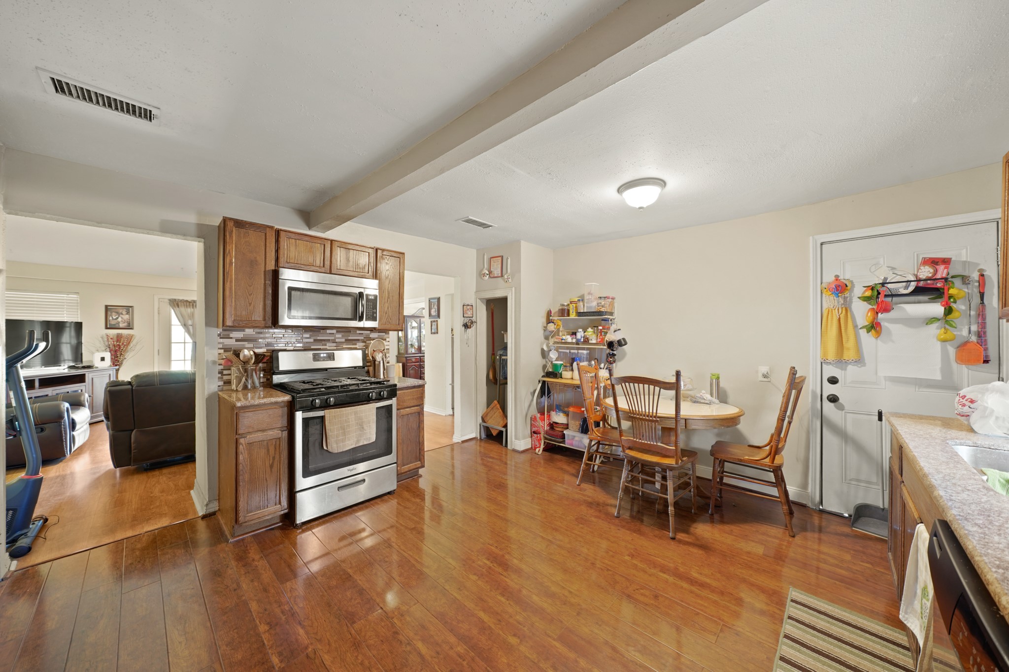 5307 Crane Street Houston, TX 77026 - Photo 36 of 41 a kitchen with stainless steel appliances a stove a refrigerator cabinets and a dining table