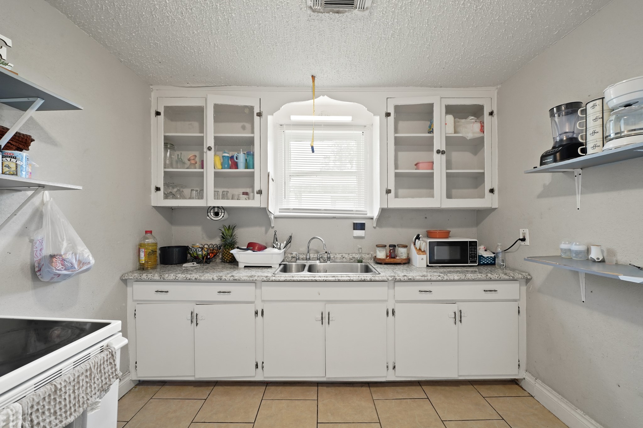5307 Crane Street Houston, TX 77026 - Photo 7 of 41 a kitchen with a sink stove and cabinets