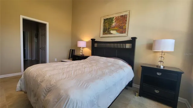 a bedroom with a bed and a lamp