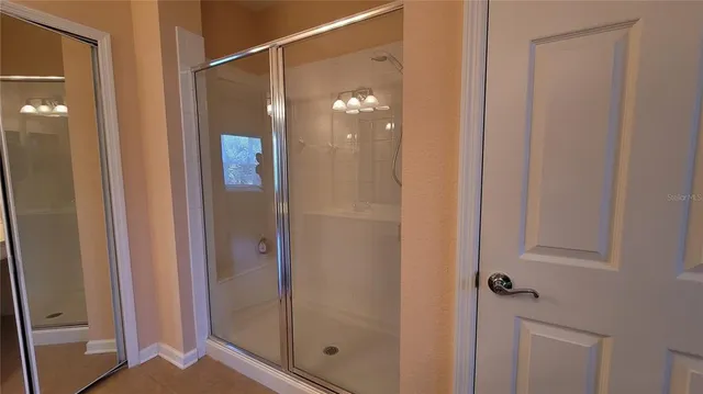 a bathroom with a shower and a mirror