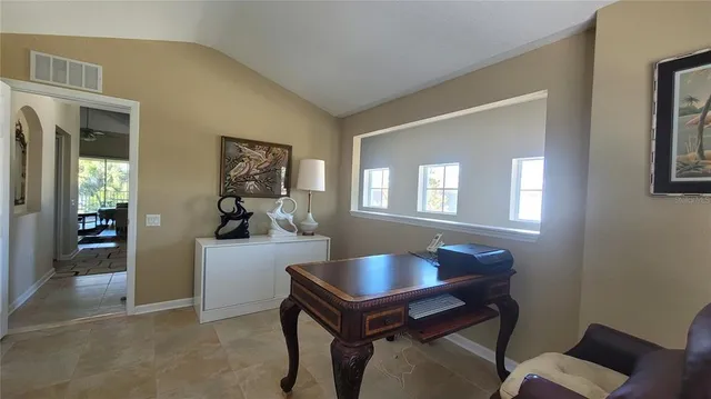 a room with a table chairs and wooden floor