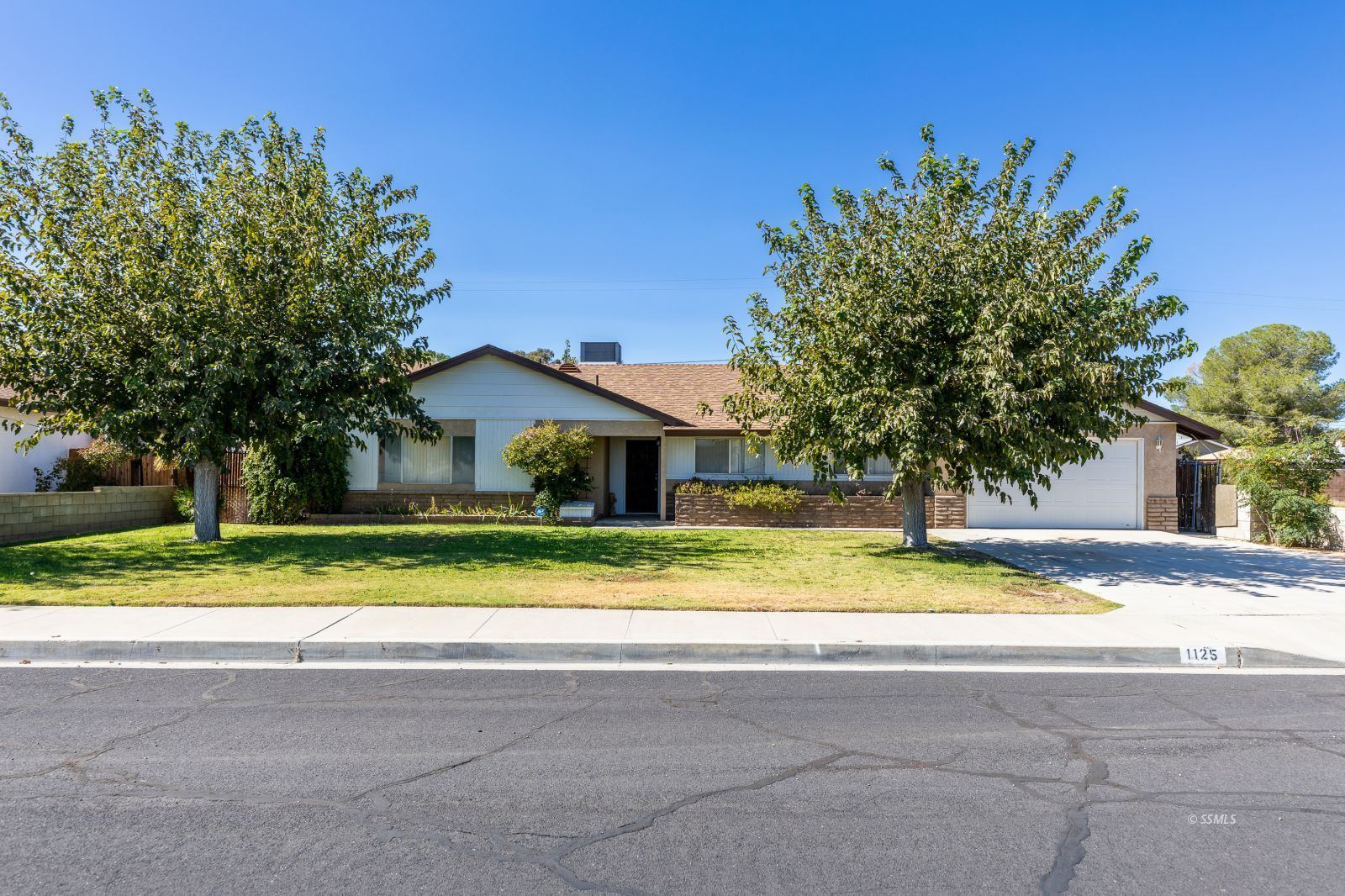 1125 South Norma Street Ridgecrest, CA 93555 - Photo 1 of 34 a view of house with outdoor space and trees