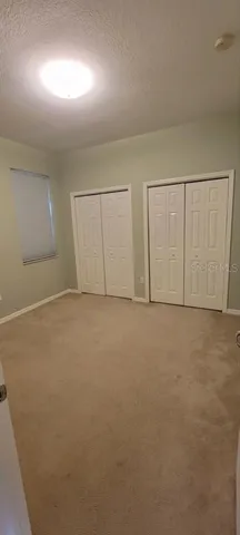 a view of a house with backyard and porch