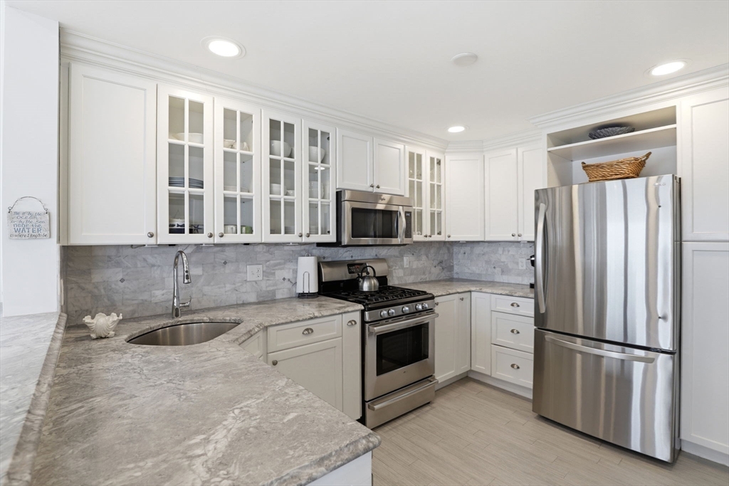 60 Holbrook Avenue Hull, MA 02045 - Photo 12 of 37 a kitchen with stainless steel appliances granite countertop a stove a sink and a refrigerator