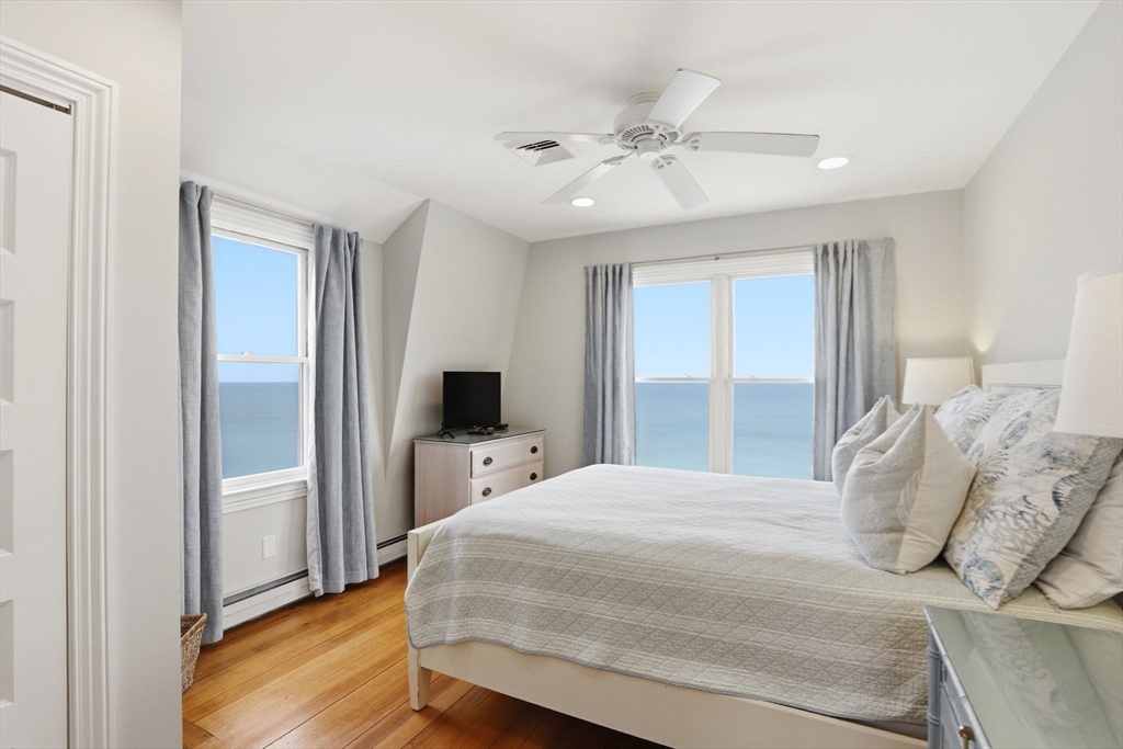 60 Holbrook Avenue Hull, MA 02045 - Photo 18 of 37 a bedroom with a large bed and a flat tv screen