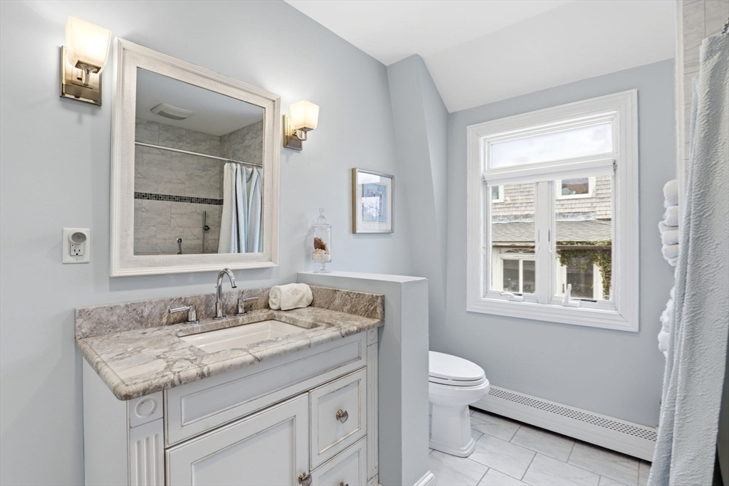 60 Holbrook Avenue Hull, MA 02045 - Photo 24 of 37 a bathroom with a granite countertop sink a toilet and a mirror