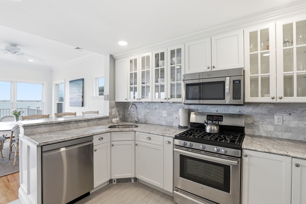 60 Holbrook Avenue Hull, MA 02045 - Photo 37 of 37 a kitchen with stainless steel appliances granite countertop a stove microwave and cabinets
