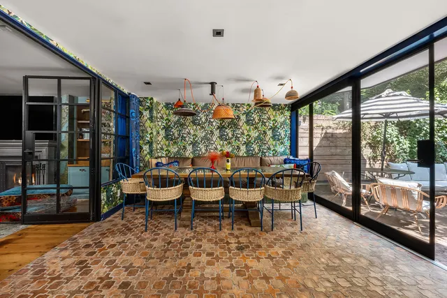 a dining room with furniture a garden and patio