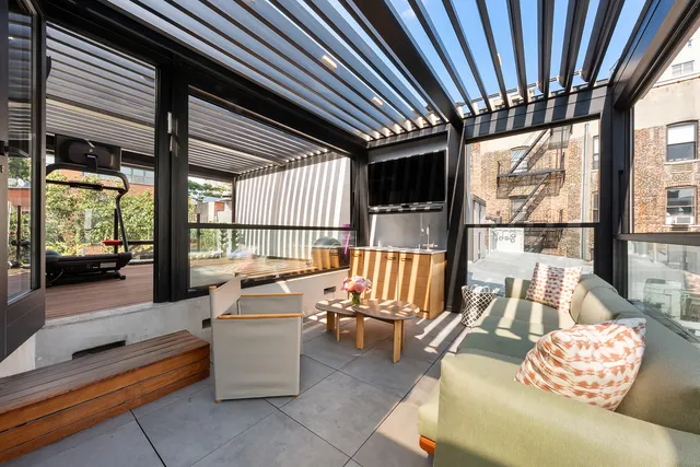 a living room with a large window and a kitchen view