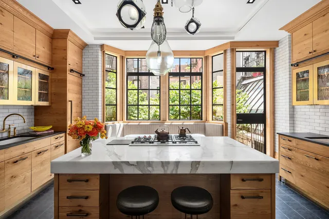 a kitchen with a window a sink and chairs