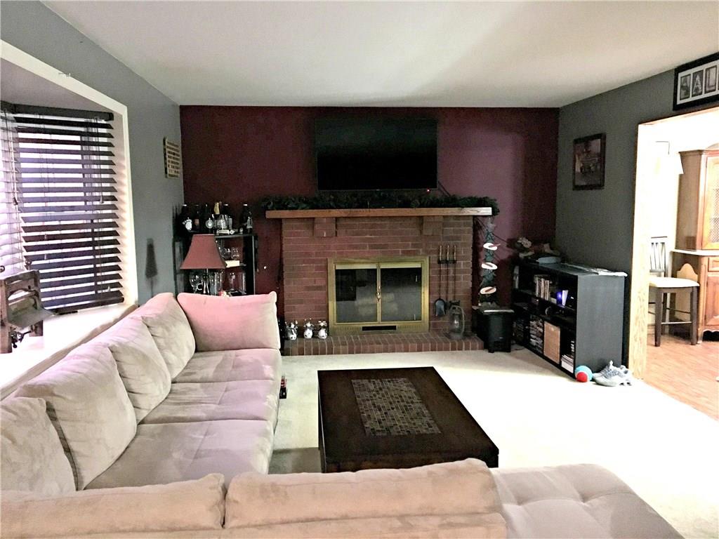 Spacious living room features both a fireplace and bay window.