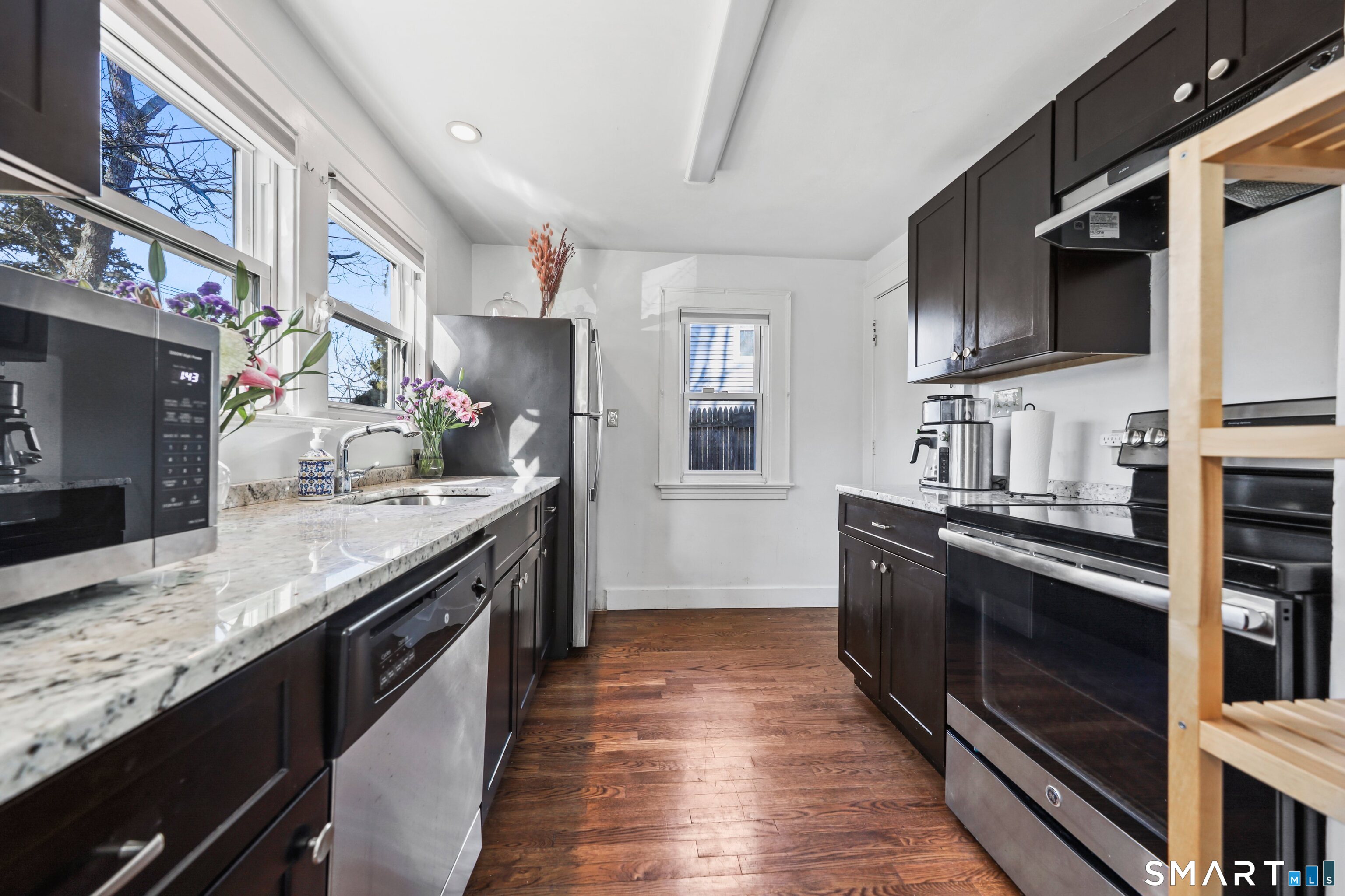 196 Waite Street Hamden, CT 06517 - Photo 4 of 15 a kitchen with stainless steel appliances granite countertop a stove a sink and a refrigerator