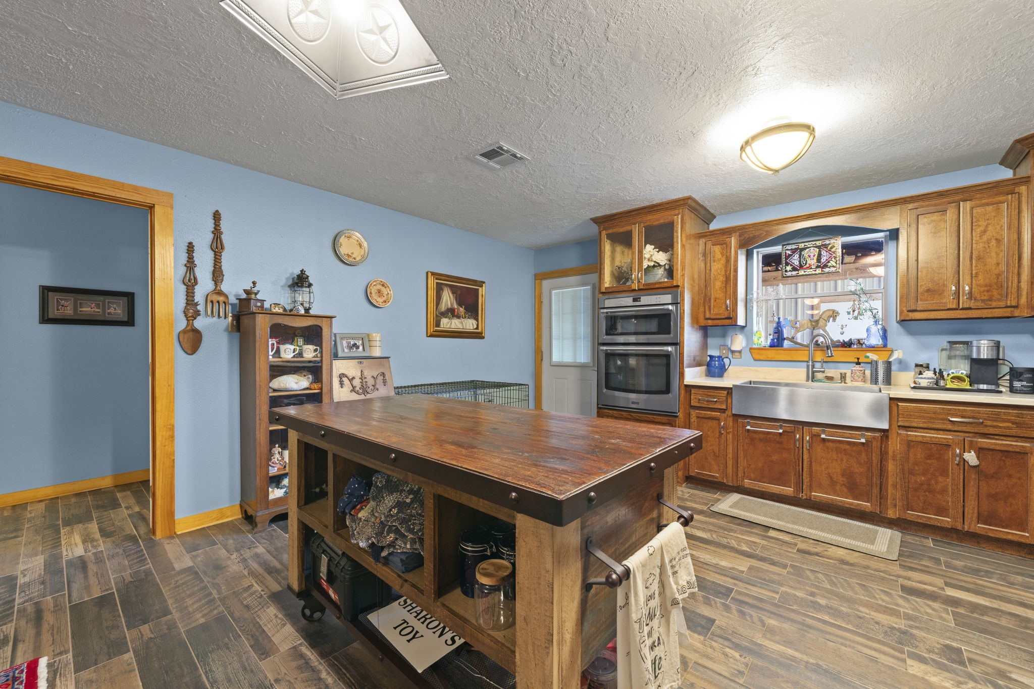 15610 Penick Road Waller, TX 77484 - Photo 33 of 49 a kitchen with stainless steel appliances granite countertop a stove top oven a sink dishwasher and cabinets with wooden floor