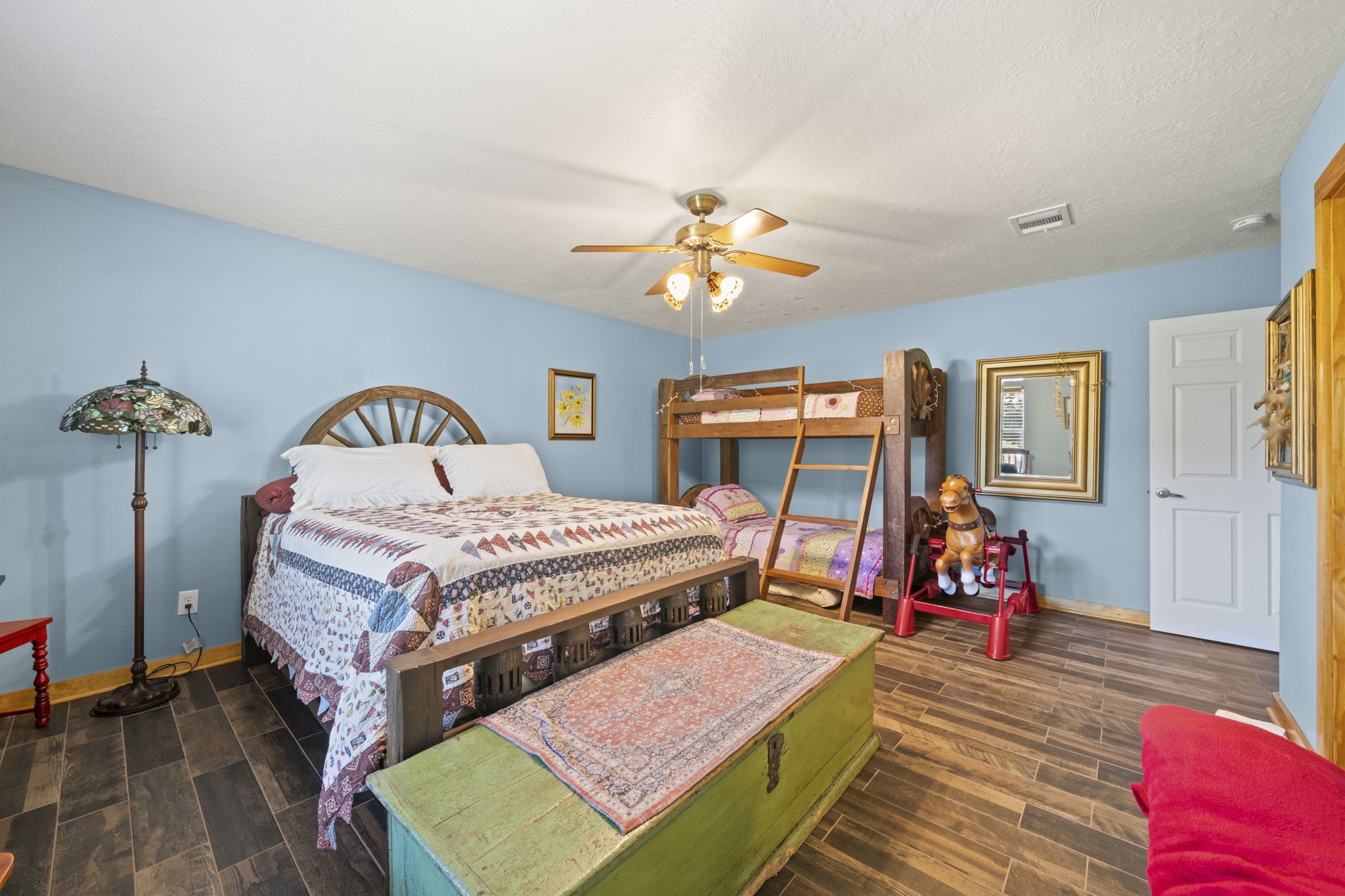 15610 Penick Road Waller, TX 77484 - Photo 34 of 49 a bedroom with a bed and a chandelier