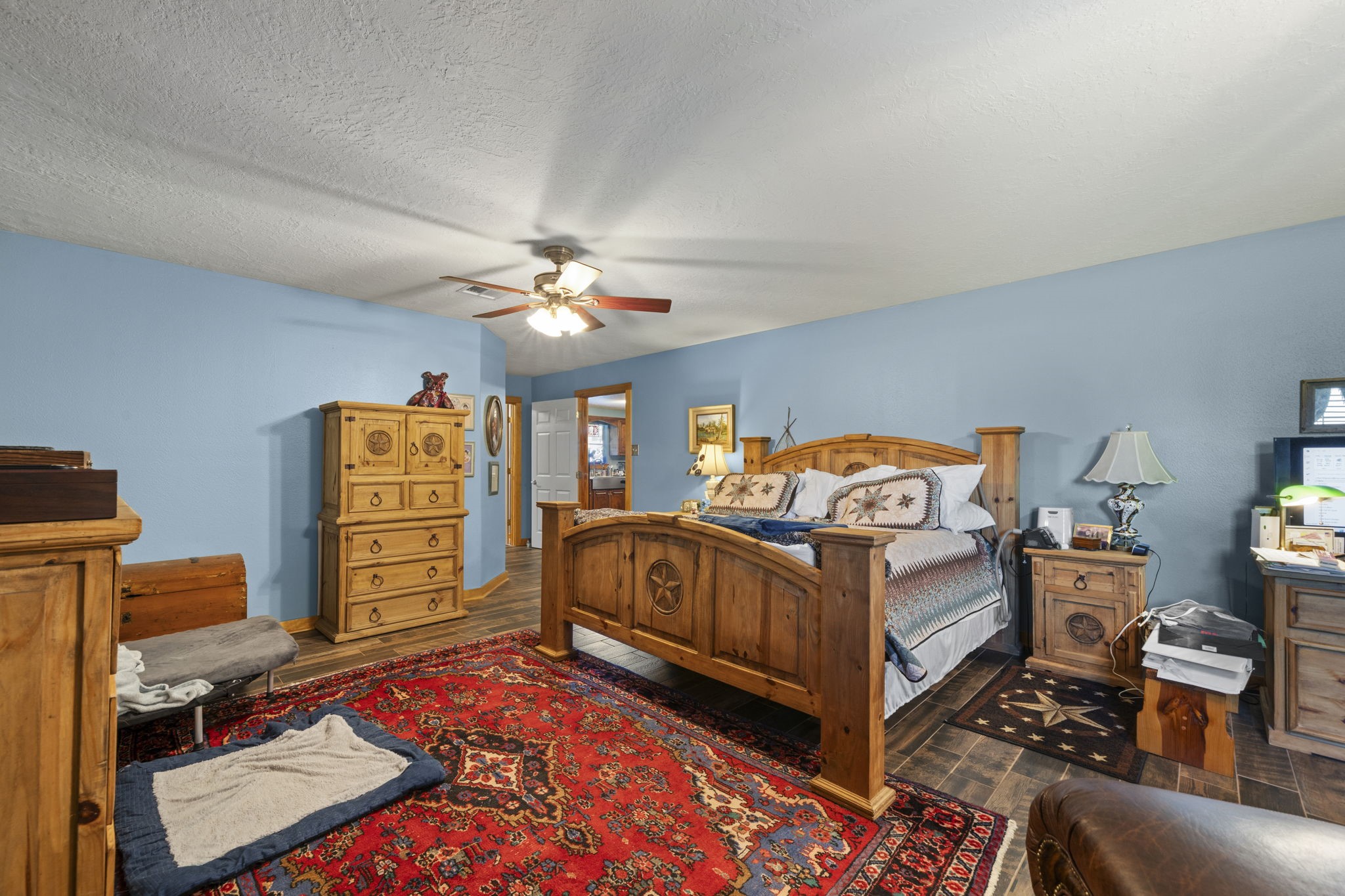 15610 Penick Road Waller, TX 77484 - Photo 35 of 49 a bedroom with furniture and a chandelier