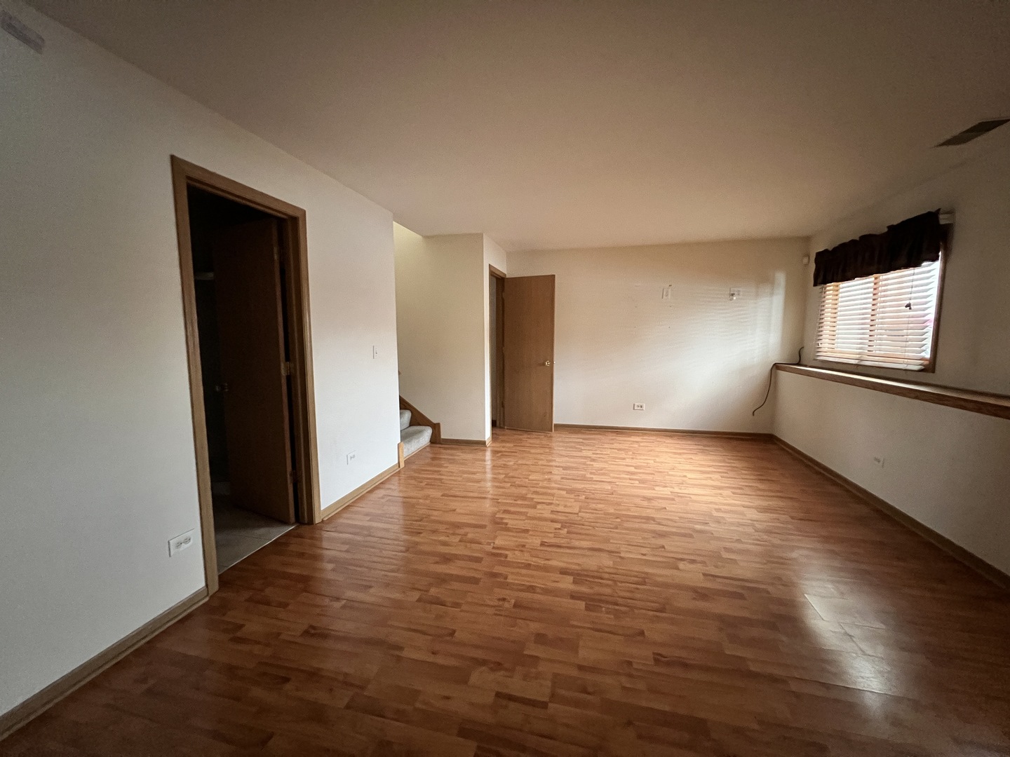 8256 Chestnut Court Frankfort, IL 60423 - Photo 21 of 22 a view of an empty room with wooden floor and a window