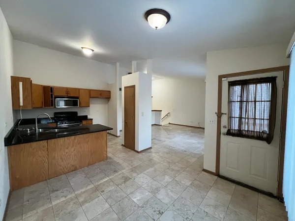 a kitchen with stainless steel appliances granite countertop a refrigerator and a stove