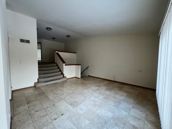 a view of an empty room with stairs
