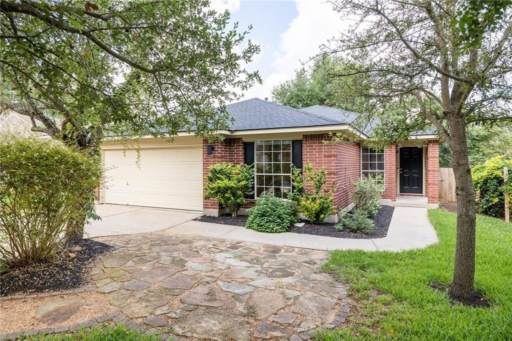 4526 Corran Ferry Loop Austin, TX 78749 - Photo 2 of 25 Mature trees shade a classic brick exterior complete with a two-car garage and paved walkway.