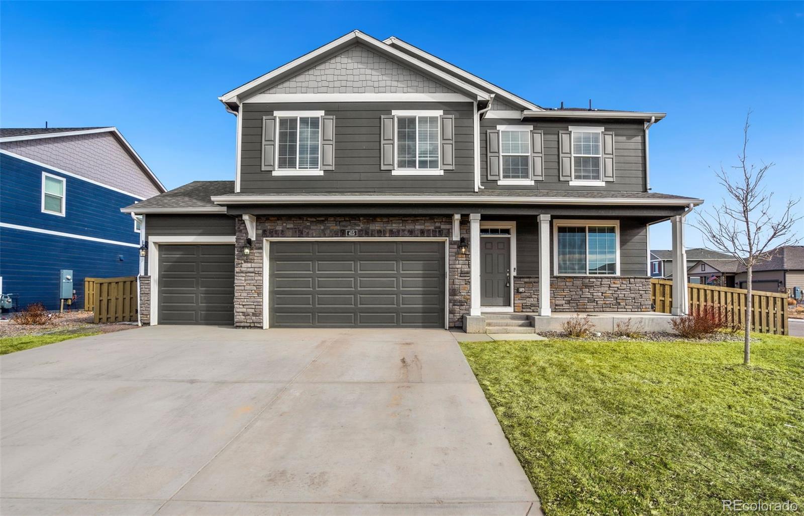 415 3rd Street Severance, CO 80550 - Photo 1 of 27 a front view of a house with a yard and garage