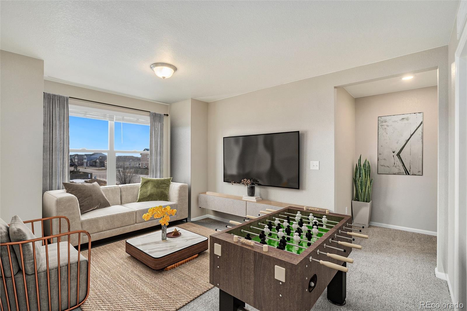 415 3rd Street Severance, CO 80550 - Photo 13 of 27 a living room with furniture and a flat screen tv