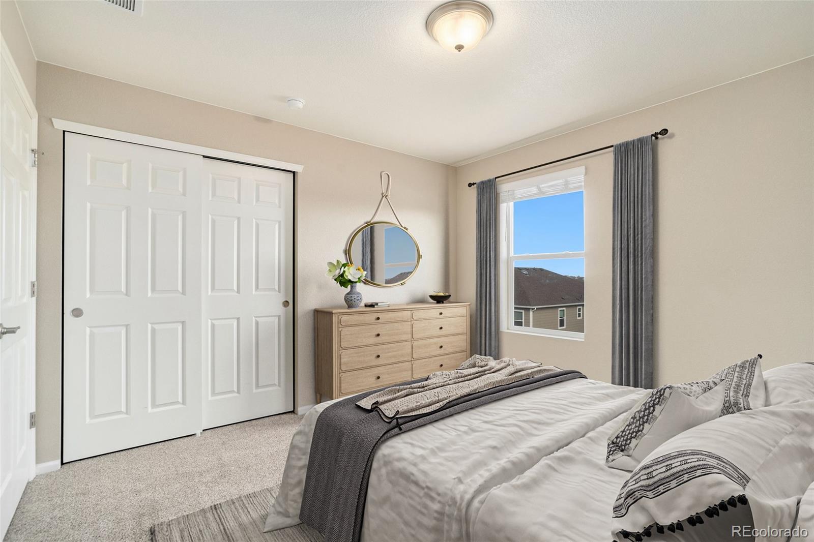 415 3rd Street Severance, CO 80550 - Photo 18 of 27 a bedroom with a bed and a mirror