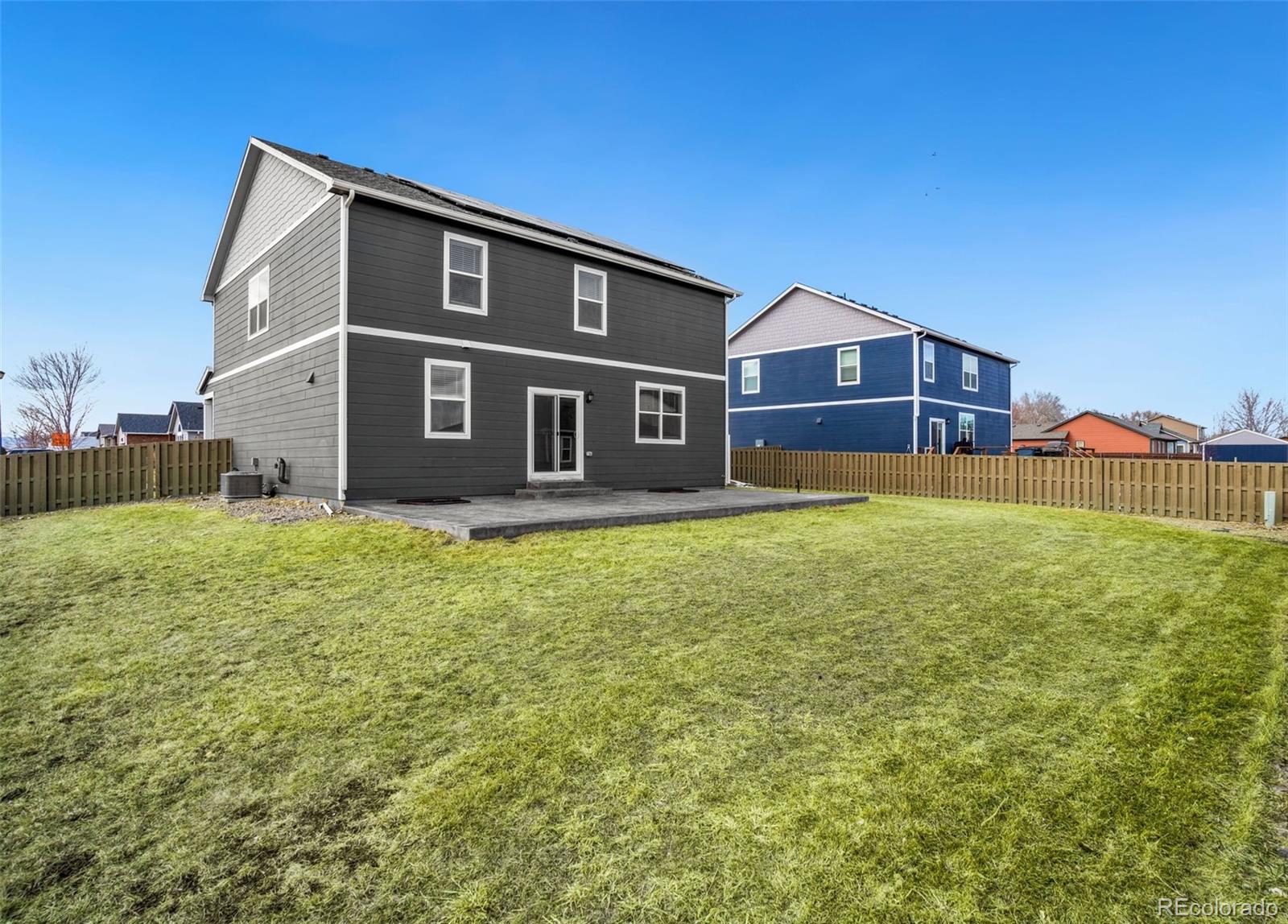 415 3rd Street Severance, CO 80550 - Photo 26 of 27 a front view of house with yard and tress in the background