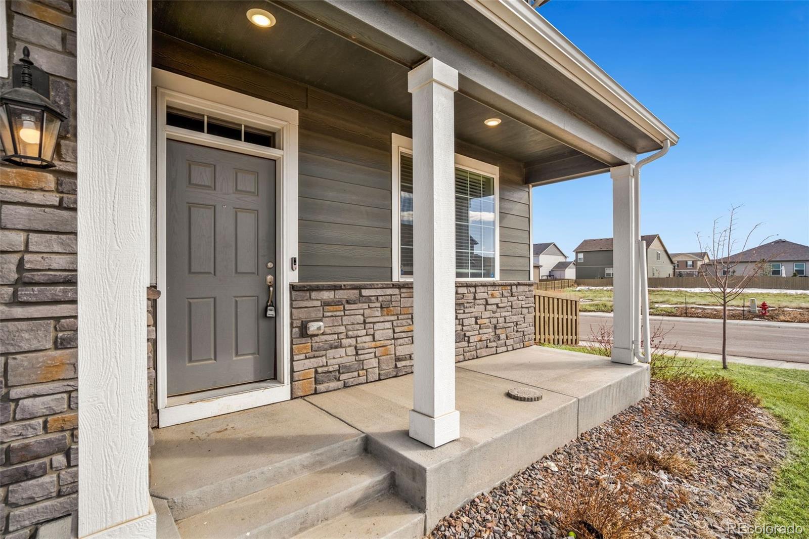 415 3rd Street Severance, CO 80550 - Photo 4 of 27 a view of a terrace with a floor to ceiling window and wooden fence