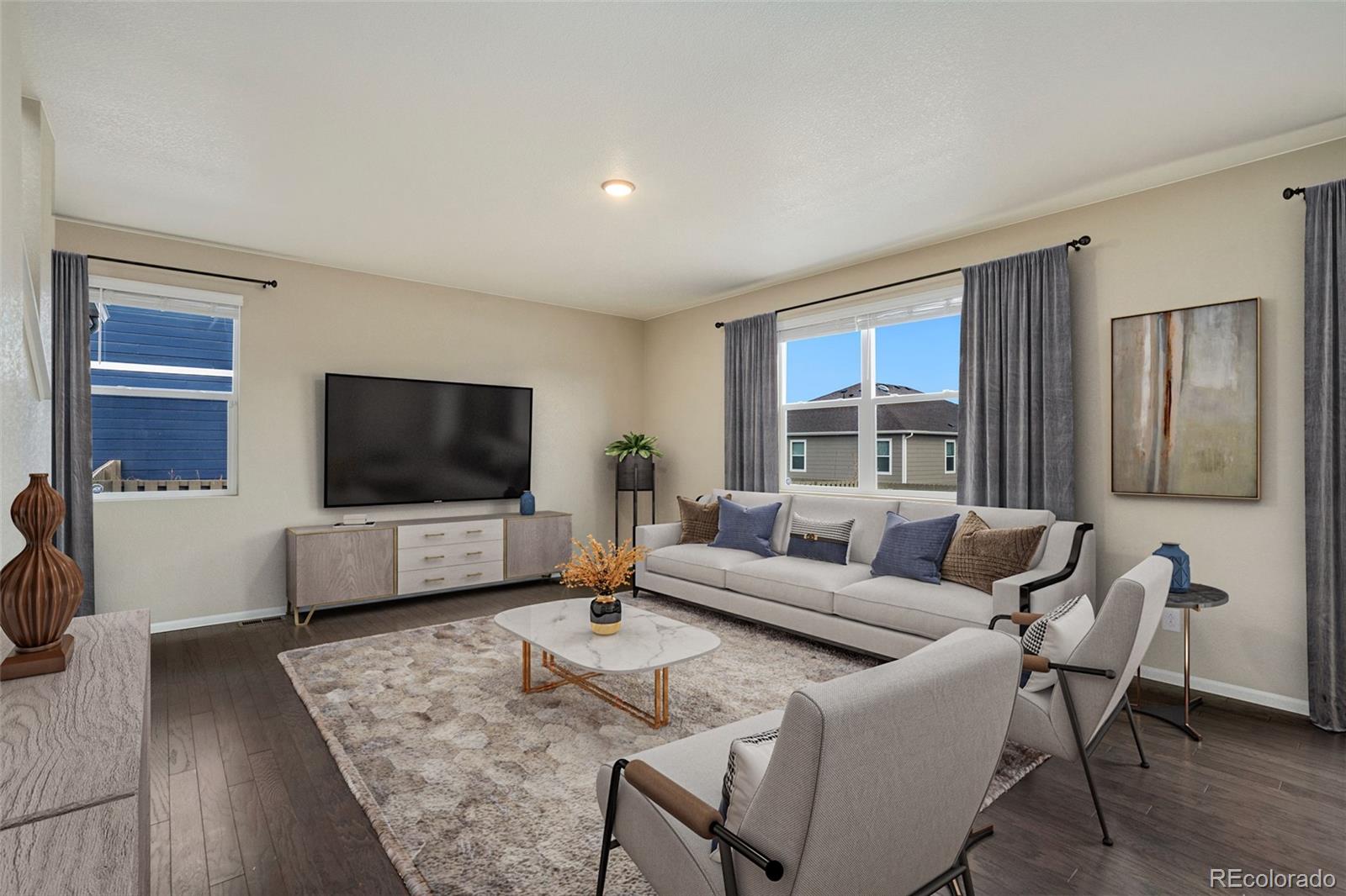 415 3rd Street Severance, CO 80550 - Photo 7 of 27 a living room with furniture and a flat screen tv