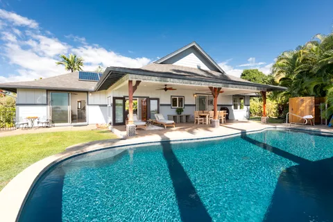 a front view of a house with swimming pool having outdoor seating