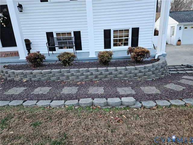 a view of a house with backyard space and a patio