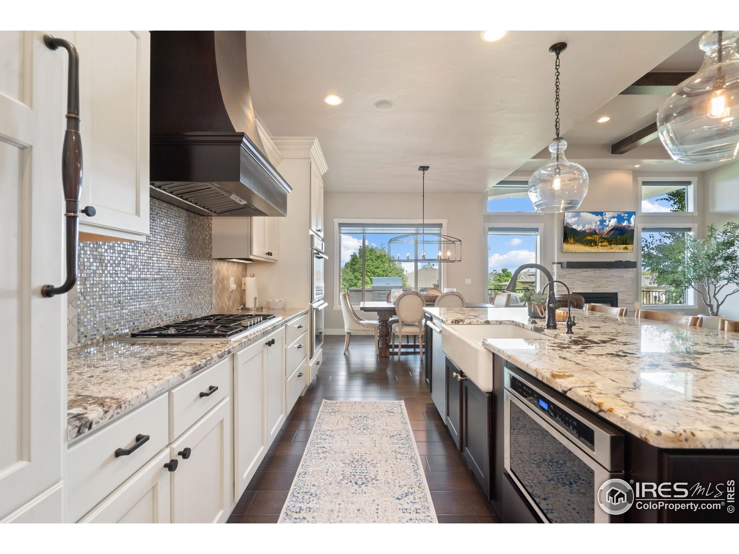 3828 Valley Crest Drive Timnath, CO 80547 - Photo 11 of 50 a kitchen with a sink stove and cabinets