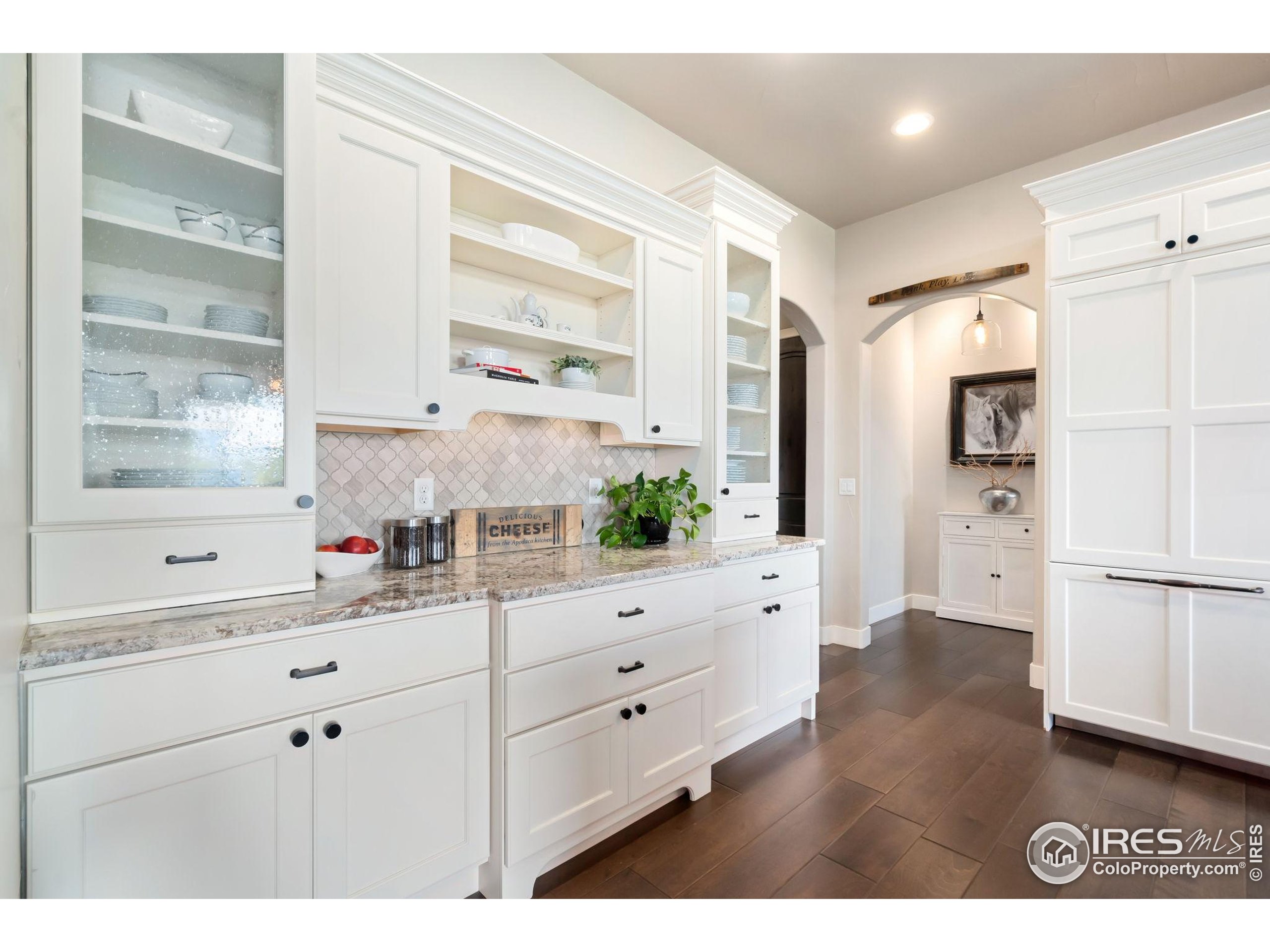 3828 Valley Crest Drive Timnath, CO 80547 - Photo 13 of 50 a kitchen with white cabinets and white appliances