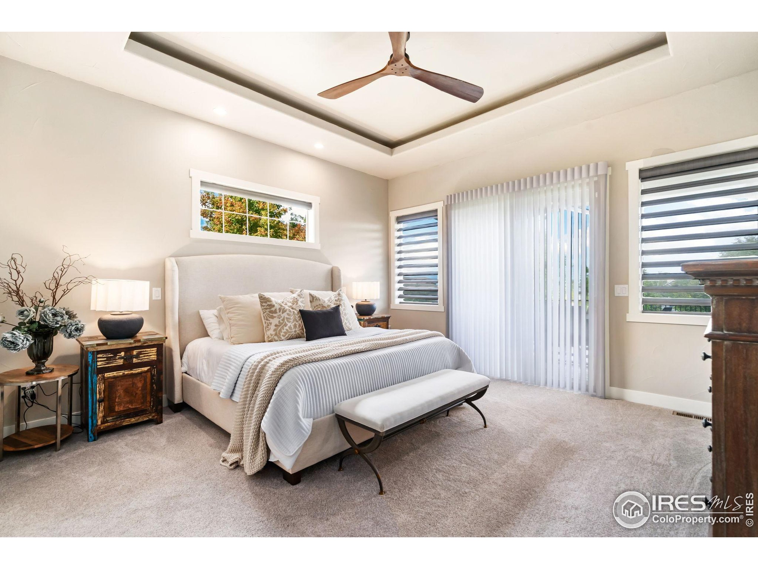 3828 Valley Crest Drive Timnath, CO 80547 - Photo 17 of 50 a spacious bedroom with a bed and a chandelier