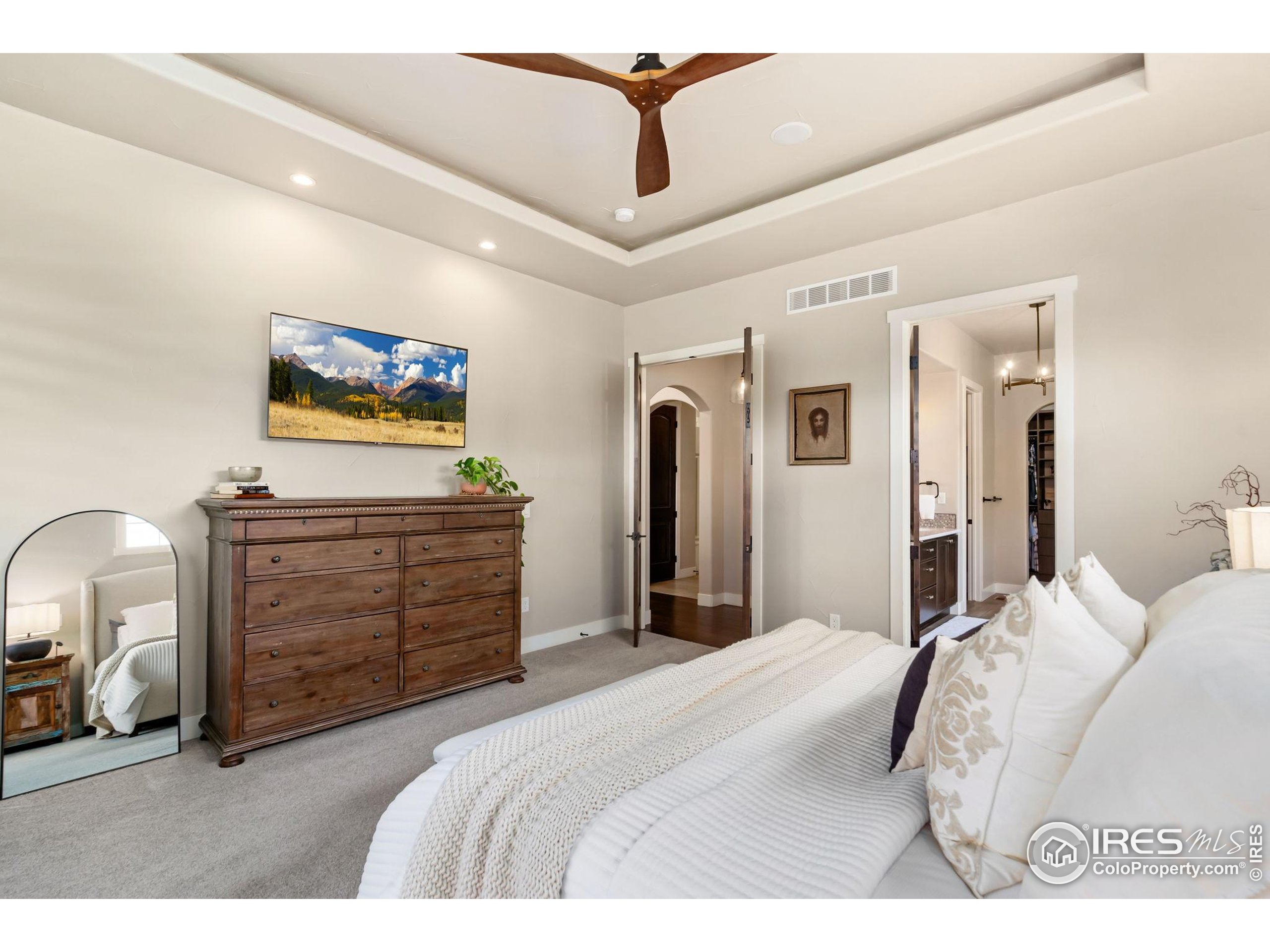 3828 Valley Crest Drive Timnath, CO 80547 - Photo 18 of 50 a bedroom with a bed and a flat screen tv