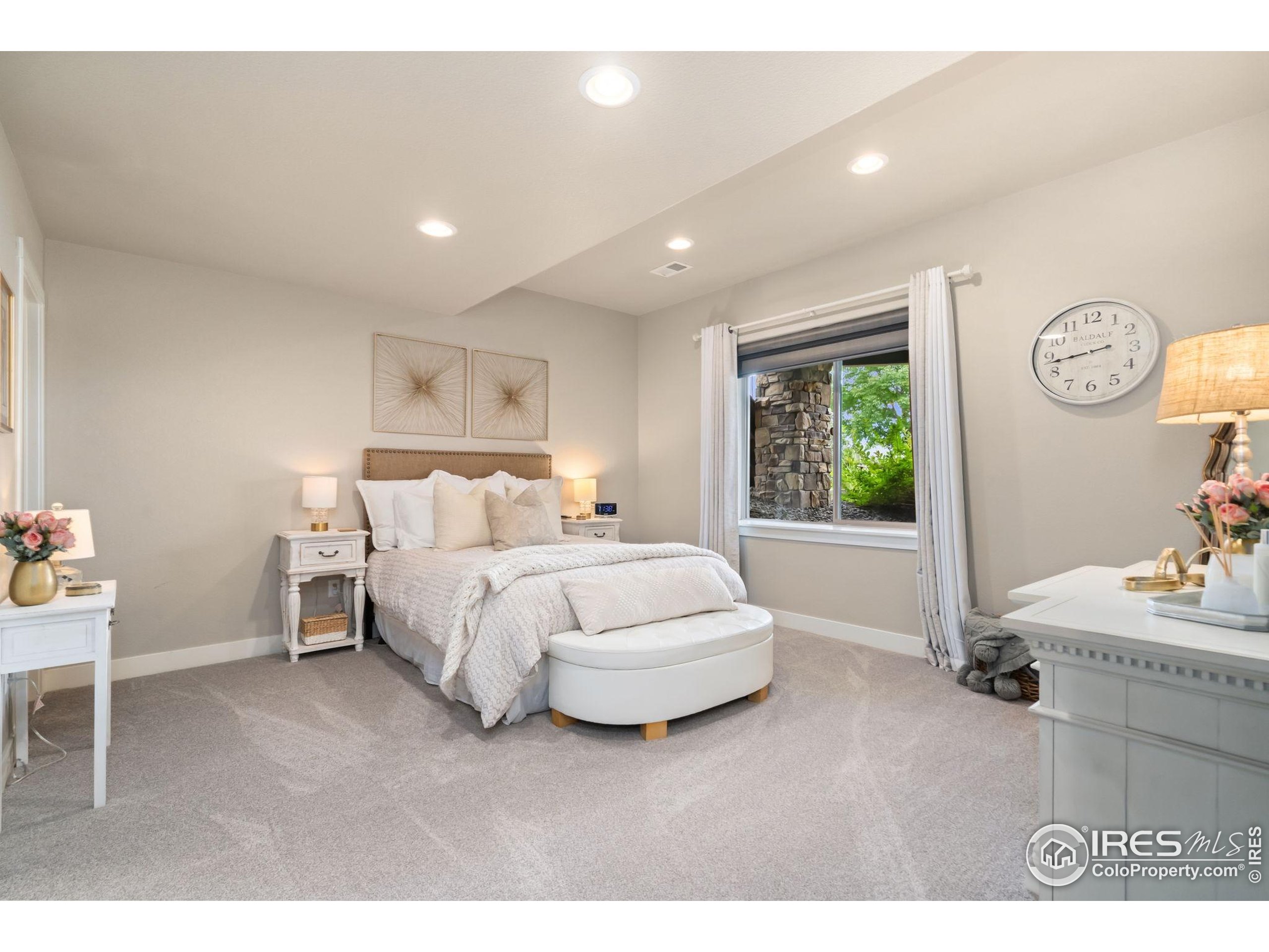 3828 Valley Crest Drive Timnath, CO 80547 - Photo 30 of 50 a bedroom with a bed and a window