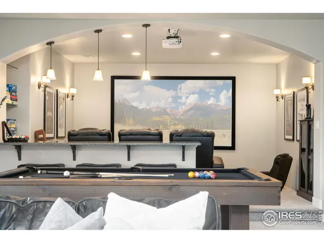 a living room with stainless steel appliances kitchen island a table and chairs