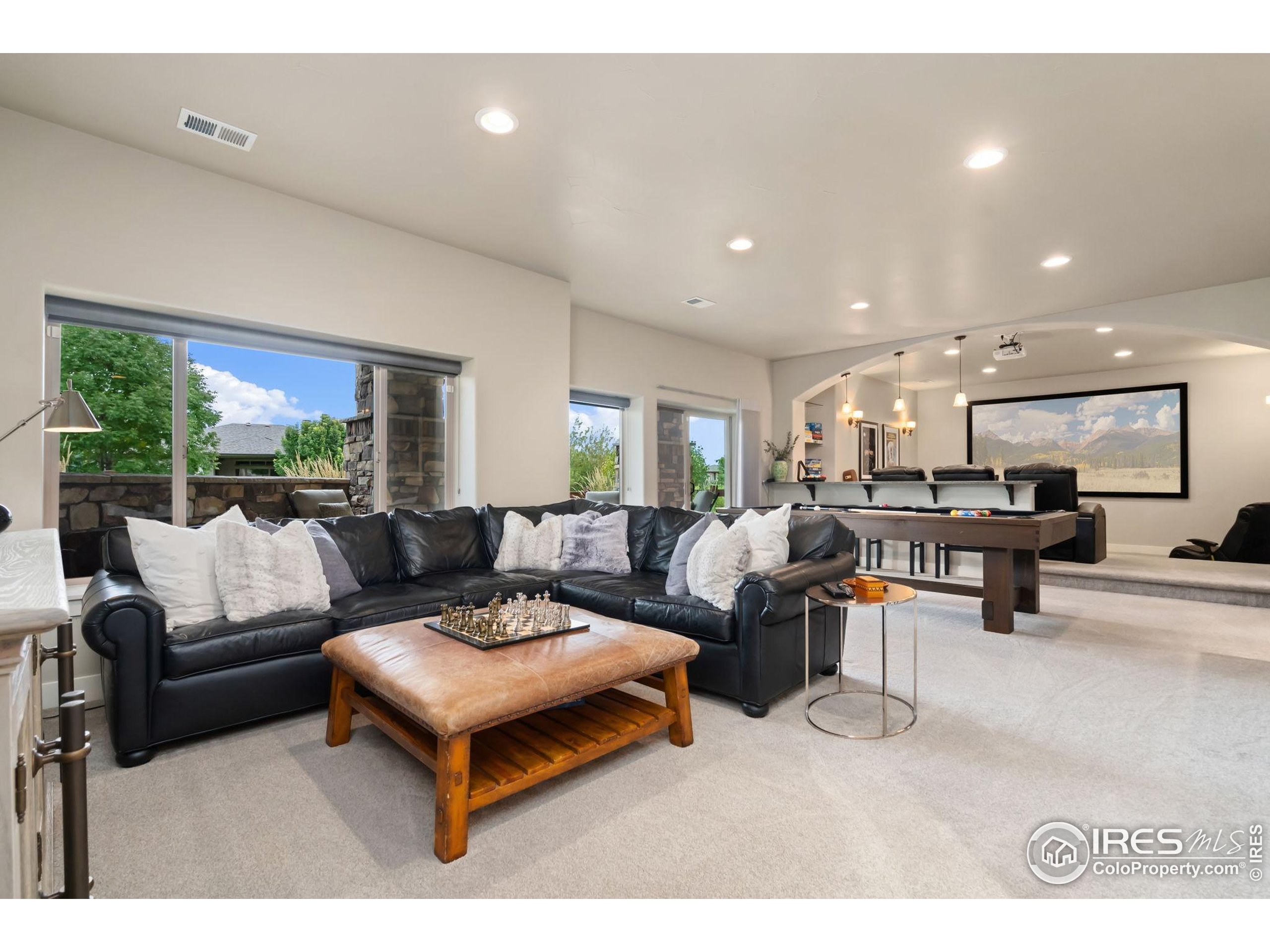 3828 Valley Crest Drive Timnath, CO 80547 - Photo 36 of 50 a living room with furniture and a large window