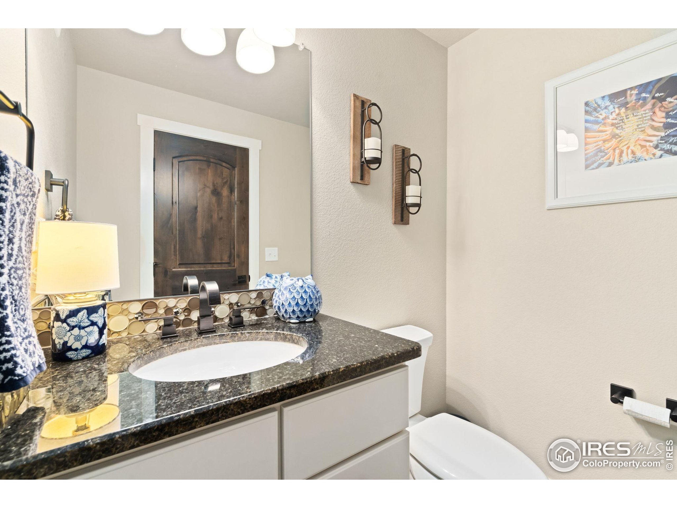 3828 Valley Crest Drive Timnath, CO 80547 - Photo 42 of 50 a bathroom with a granite countertop sink and a mirror
