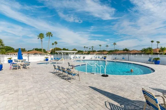 a view of a swimming pool with a lawn chairs