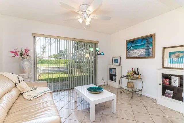 a living room with furniture and a floor to ceiling window