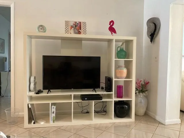 a living room with a flat screen tv and a fireplace