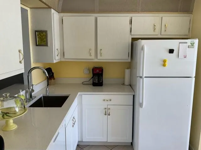 a kitchen with refrigerator and cabinets