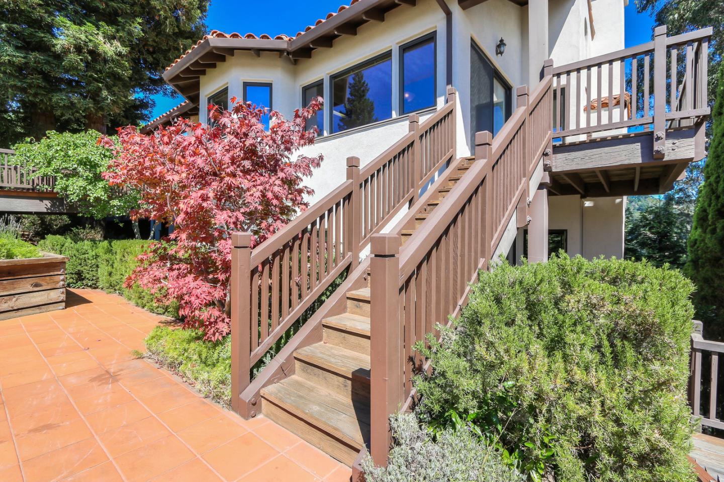 6840 Buckingham Boulevard Berkeley, CA 94705 - Photo 19 of 50 a front view of a house with a yard and potted plants