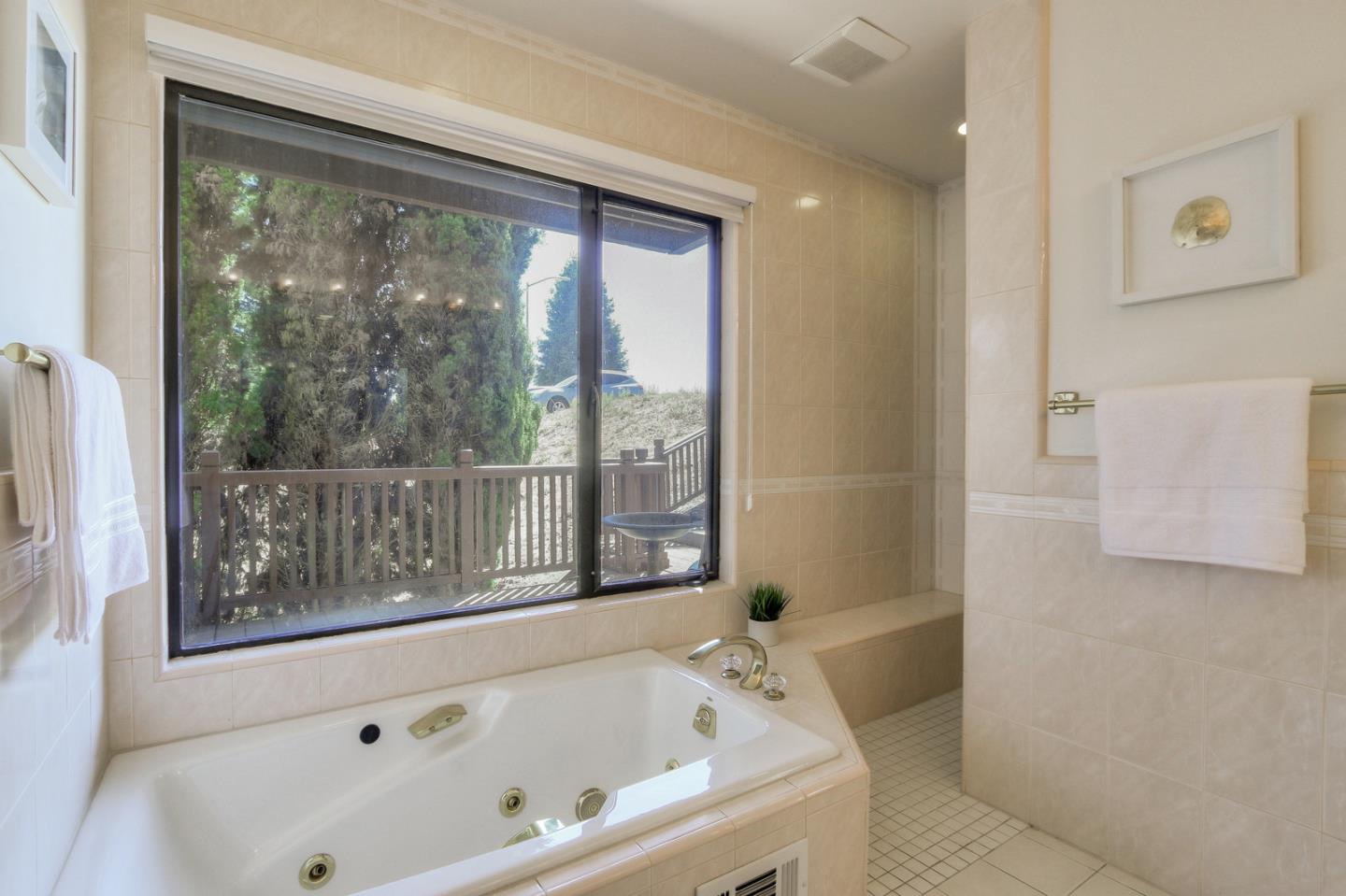 6840 Buckingham Boulevard Berkeley, CA 94705 - Photo 28 of 50 a bathroom with a bathtub and window