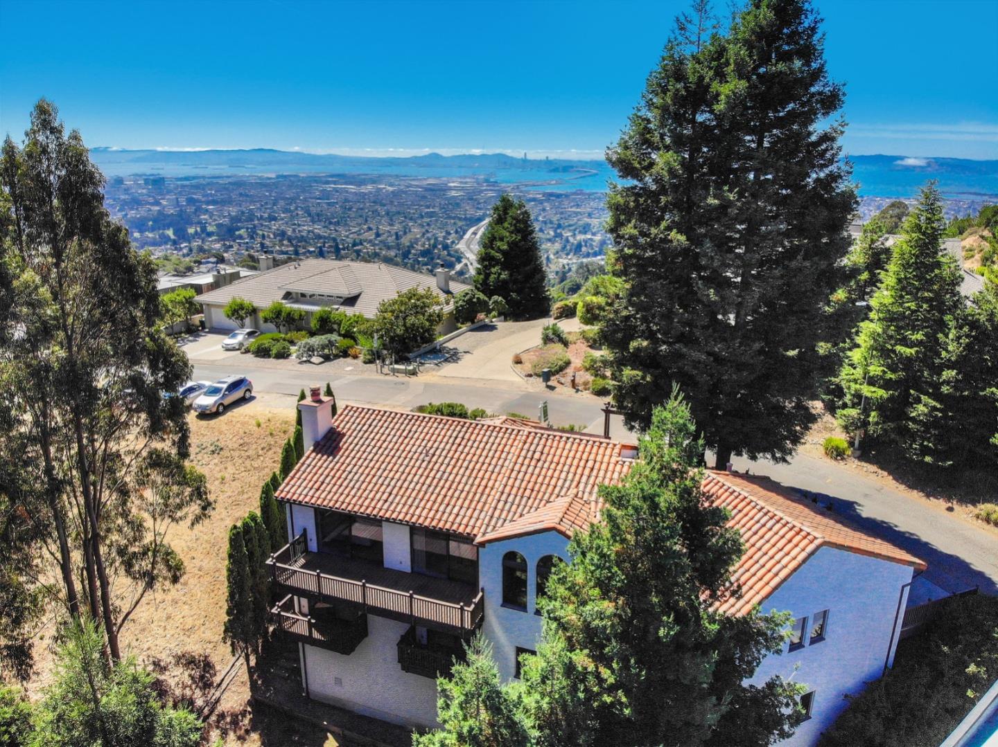 6840 Buckingham Boulevard Berkeley, CA 94705 - Photo 7 of 50 an aerial view of a house with a yard and mountain view in back